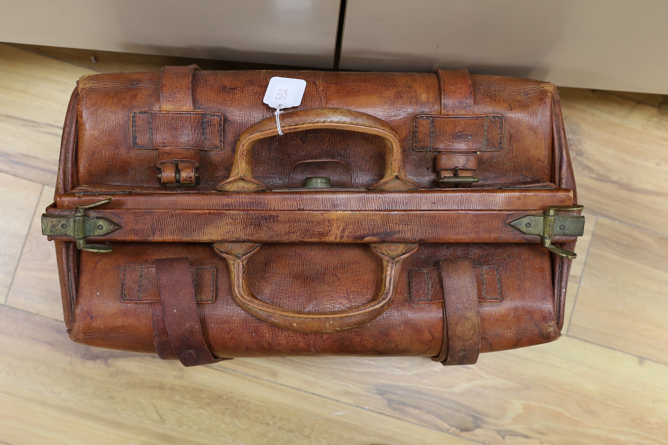 A brown leather Gladstone bag